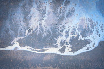 Beautiful abstract stain of motor oil, gas or petrol spilled on the asphalt