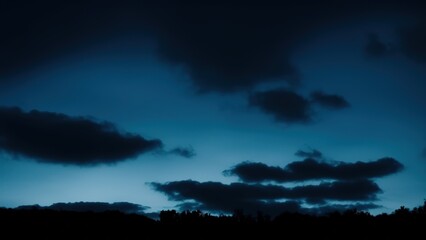 Fototapeta na wymiar Heavy gloomy dull thunderclouds. Dark teal dramatic night sky.