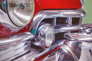 Side view of a vintage fifties red classic car with chrome accents
