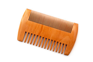 Small brown wooden comb for hair of beard isolated on white - obrazy, fototapety, plakaty