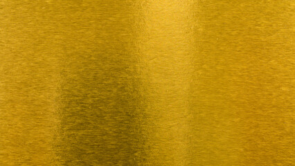 Abstract paper golden for Merry Christmas and Happy new year.
Gradation gold foil leaf shiny with sparkle yellow metallic texture background.
top view.