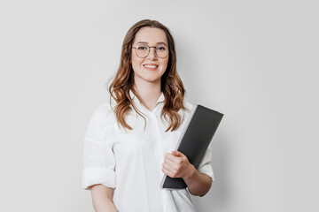 Woman psychologist in a white shirt with glasses on a white background in the studio - obrazy, fototapety, plakaty