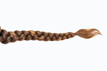 Female hair in the form of a braid on a white isolated background. Red hair braided close-up....
