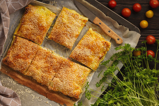 Homemade crispy puff pastry pie with zucchini, ham and mozzarella.