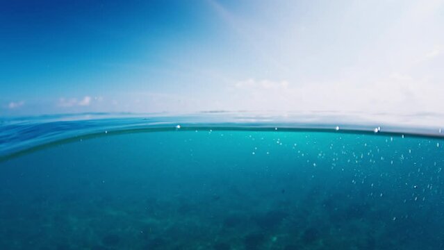 Splited view of the sea and reef in the Maldives during sunny day