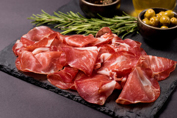 Italian slices of coppa, capocollo, capicollo, bresaola or cured ham with rosemary. Raw food.   - obrazy, fototapety, plakaty
