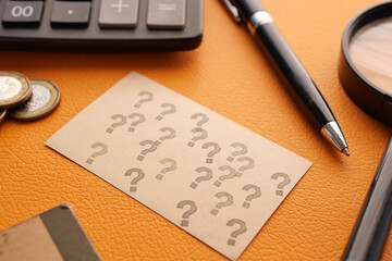 high angle view of question mark on paper on office desk