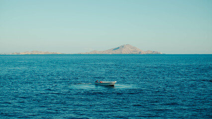 a small boat in the middle of the sea