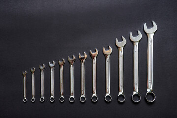 Set of wrenches on black background. Tools spanners. Technique repair, equipment for mechanical service, labor or father's day concept. Flat lay, top view, copy space