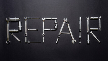 Text REPAIR made of tool set on black background. Mechanic tools, wrenches or spanners. Technique repair, equipment for mechanical service, labor or father's day concept