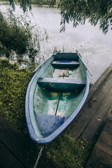 A boat near a wooden pier on the river