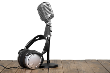 Retro microphone and modern headphones on table