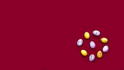 Colored chocolate eggs on Magenta background. Easter design concept in 2023 trendy colors. Close-up