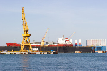 Obraz premium Cargo ship in a shipyard at anchor for repairs.Shipbuilding industry