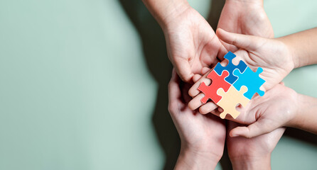 Color puzzle symbol of awareness for autism spectrum disorder family support. Father, Mother, Children holding jigsaw puzzle Autism World Awareness Day.