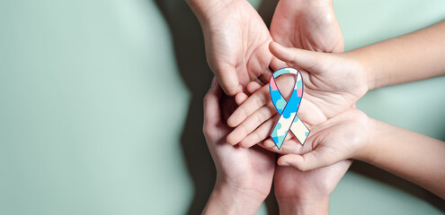 Father, Mother, Children holding ribbon jigsaw puzzle, Color puzzle symbol of awareness for autism spectrum disorder family support. Autism World Awareness Day.