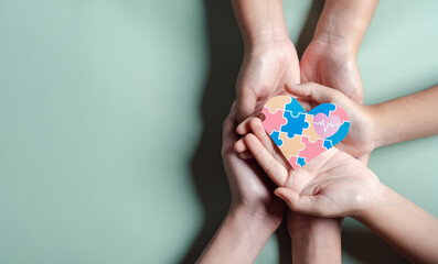 Father, Mother, Children holding heart jigsaw puzzle, Color puzzle symbol of awareness for autism spectrum disorder family support. Autism World Awareness Day.