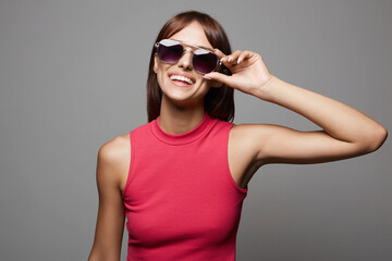 Fototapeta premium Happy beautiful Girl in Sunglasses. Smiling young woman