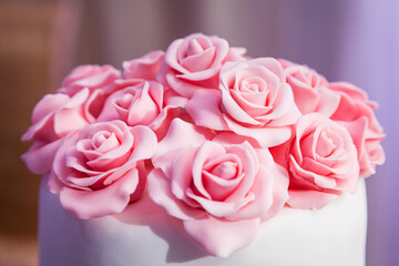 pink roses from mastic close-up - decoration on the wedding cake