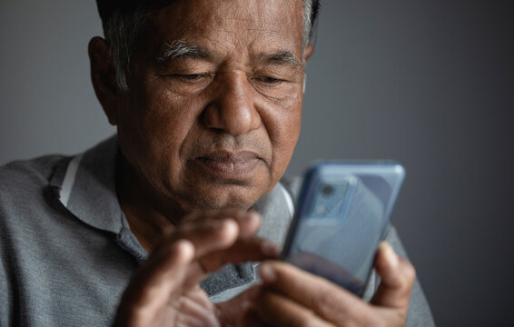 Portrait, Sad Old Man, Unhappy Elderly Man Thinking While Using Smart Phone At Home