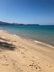 beach, palm trees and Andaman sea in Thailand on Phuket island