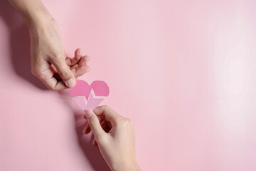 Obraz na płótnie Canvas Hands holding pink heart donation concept, health care, organ donation, family life insurance, world heart day, world health day, praying concept