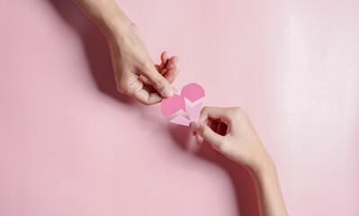 Obraz na płótnie Canvas Hands holding pink heart donation concept, health care, organ donation, family life insurance, world heart day, world health day, praying concept