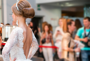 Competition among wedding stylists. A model in a wedding dress, with hair and make-up shows the...