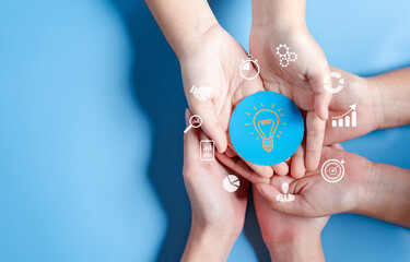 Hands holding light bulb with business target planning development leadership and customer target group, investment growth and success development, achievement, goal, strategy, finance concept.