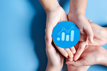 Hands holding chart growth with business target planning development leadership and customer target group, investment growth and success development, achievement, goal, strategy, finance concept.