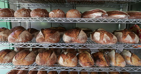 Traditional breads stacked together on shelf at bakery