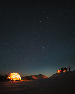 snow camping in the mountains at night