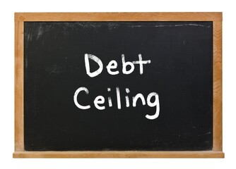 Fototapeta premium Debt ceiling limit written in white chalk on a black chalkboard isolated on white