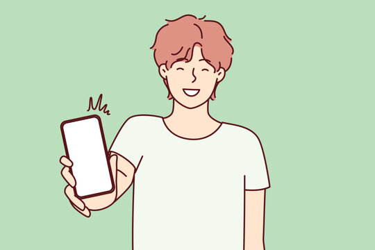 Happy Man Showing Smartphone Screen And Smiling To Recommend Cool Applications. Positive College Age Guy Holding Mobile Phone With Blank Display Boasts Website. Flat Vector Illustration