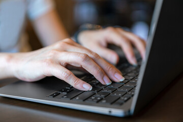 closeup hand typing keyboard on labtop of businesswoman during technology online connection business work for education and study business concept