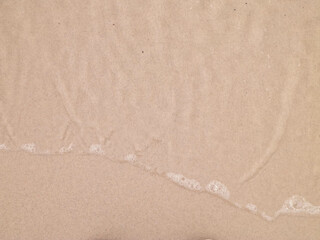 Sea water on sandy beach sand - nature background.