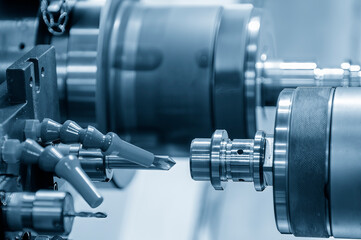 The multi-tasking CNC lathe machine  chamfer cutting the metal shaft parts by milling turret.