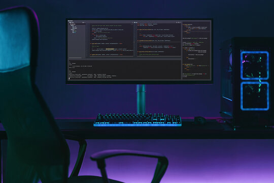 Empty programming workspace with big monitor screen shows code. Professional coder desk in neon lights. Data science concept