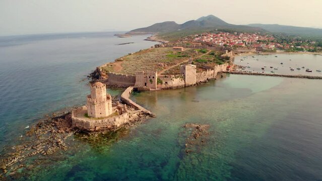 4k drone flight back footage (Ultra High Definition) of old Methoni Castle. Majestic morning seascape of Ionian sea. Calm outdoor scene of Peloponnese peninsula, Greece, Europe.
