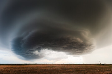 Fototapeta na wymiar Dark storm clouds over a field