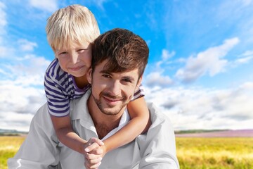 Happy young father play with cute child in park