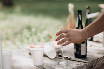 waiter pouring wine into a glass with a bottle of champagne
