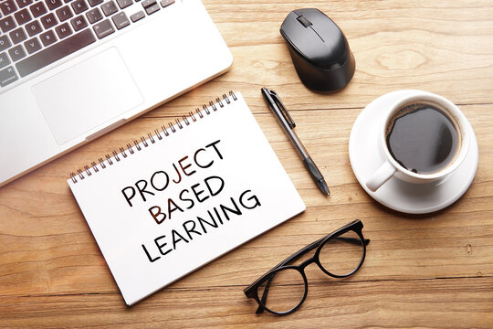 Project Based Learning, motivational words and sentences for work and life. Quote sentence in notebook with laptop, pen, coffee over wooden background.