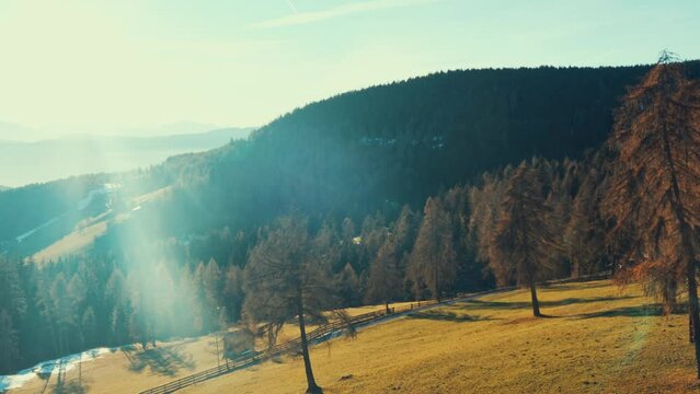 Aerial shot of the mountains of South Tyrol at sunset. 4k footage from Renon cable car, Soprabolzano, Corno del Renon. Breathtaking views of winter landscape and early melting of snow.