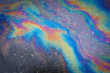 Abstract Color Gasoline fuel spots on Asphalt Road as Texture or Background.