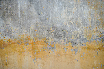 Old and grungy yellow cement wall background 