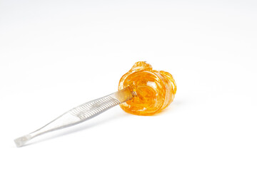 cannabis gold live resin on dab stick with high thc isolated on white background
