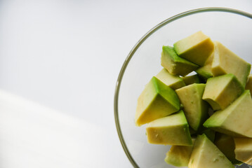 Avocado cut into small slices. Avocado salad. Peeled avocado on a plate.