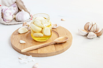 Obraz na płótnie Canvas Fermented garlic cloves in a jar of honey. Healthy food and medicine from nature, honey for strong immunity, Fermented honey with garlic, a rich source of probiotics