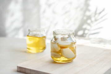 Fermented garlic cloves in a jar of honey. Healthy food and medicine from nature, honey for strong immunity, Fermented honey with garlic, a rich source of probiotics
